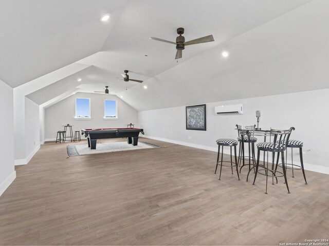 game room with a wall mounted AC, ceiling fan, billiards, and light hardwood / wood-style flooring