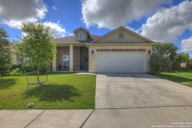 view of front of house with a front lawn and a garage