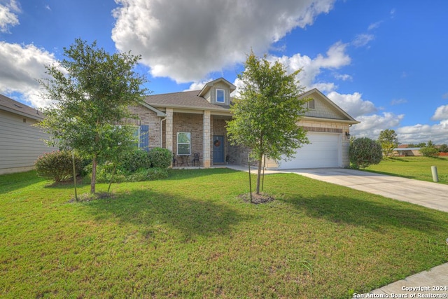 view of front of property featuring a garage and a front yard