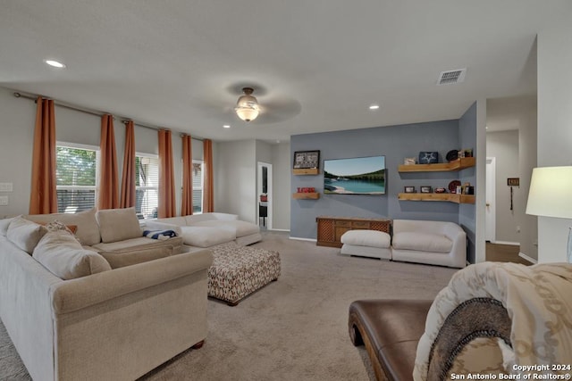 carpeted living room featuring ceiling fan