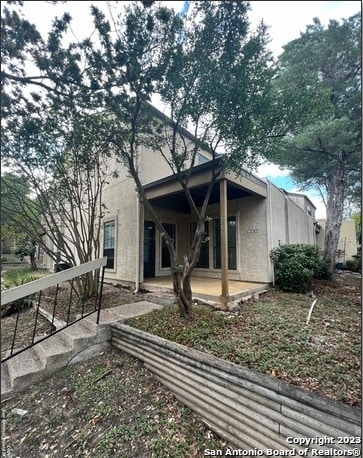 back of property featuring a patio area and stucco siding