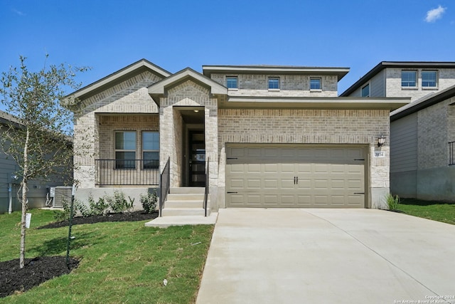 view of front facade featuring brick siding, driveway, an attached garage, and a front yard