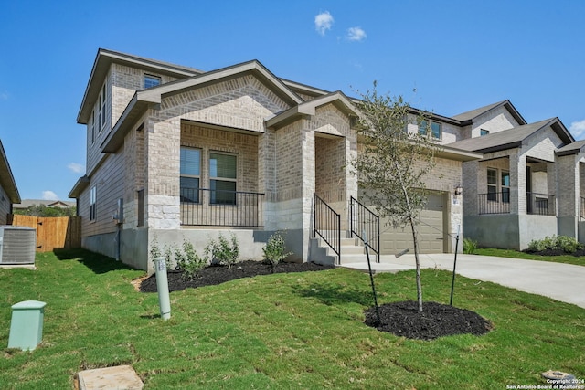 view of front facade with central AC unit, a garage, and a front lawn