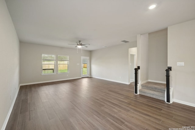 empty room with ceiling fan and dark hardwood / wood-style floors