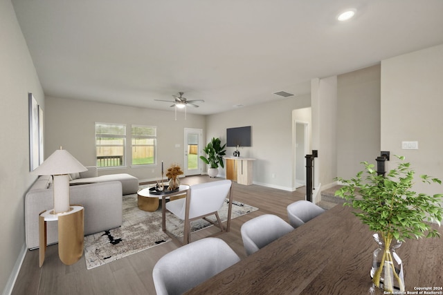 living room with wood-type flooring and ceiling fan