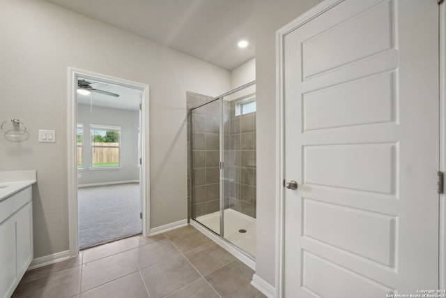 bathroom with tile patterned flooring, vanity, ceiling fan, and an enclosed shower