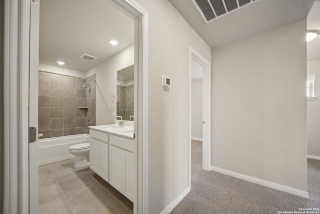 full bathroom with vanity, tile patterned flooring, tiled shower / bath, and toilet