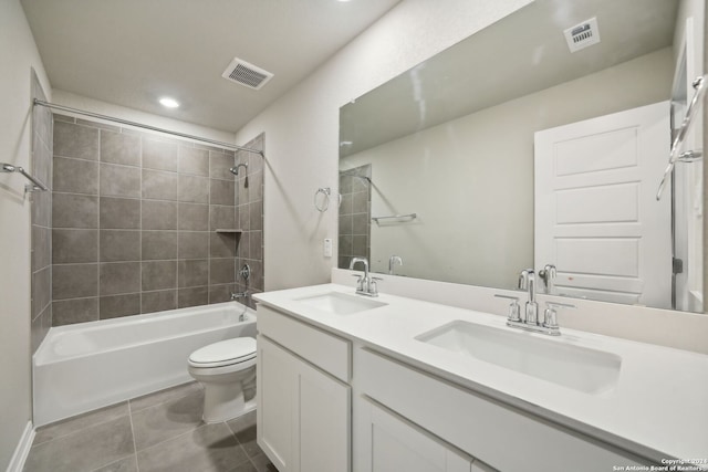 full bathroom with tile patterned floors, toilet, vanity, and tiled shower / bath