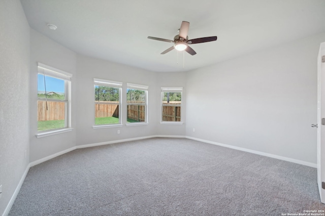 empty room with ceiling fan and carpet floors