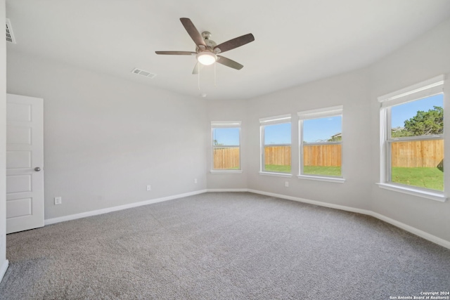 carpeted spare room with ceiling fan