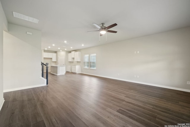 unfurnished living room featuring dark hardwood / wood-style floors and ceiling fan