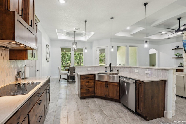 kitchen with decorative light fixtures, black electric cooktop, a raised ceiling, and stainless steel dishwasher