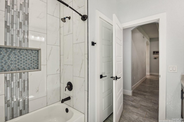 bathroom featuring hardwood / wood-style floors and tiled shower / bath combo