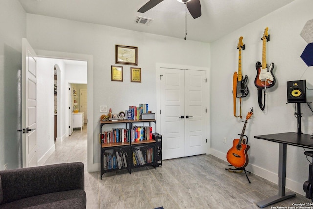 living area featuring ceiling fan and light hardwood / wood-style flooring