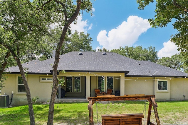 back of house featuring central air condition unit, a yard, and a patio