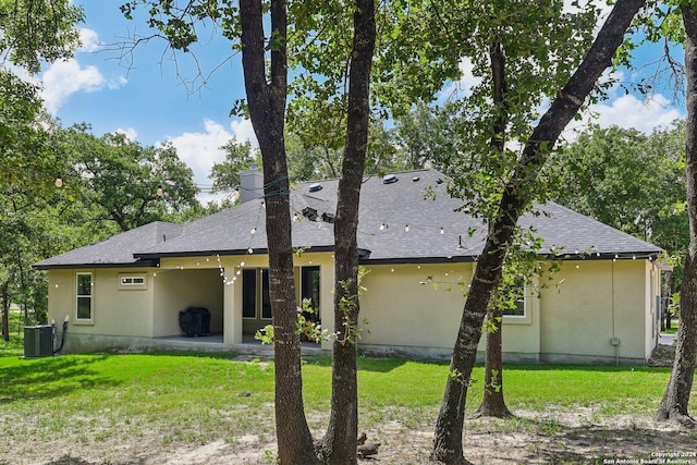 back of house with a patio, a yard, and central AC