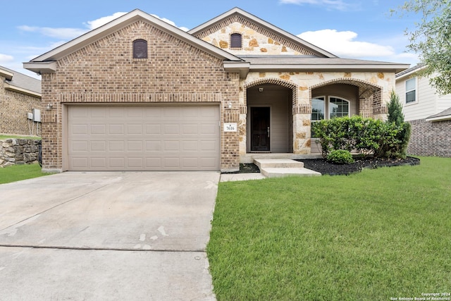 view of front facade with a front yard and a garage