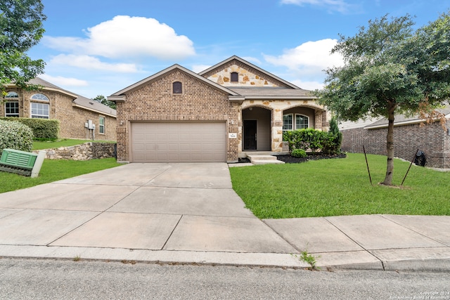 view of front of property with a front yard and a garage