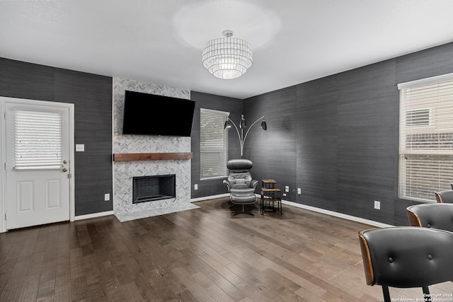 unfurnished room featuring a tile fireplace and wood-type flooring