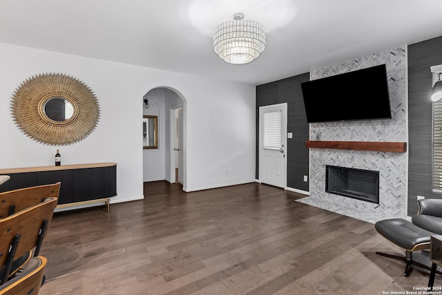 living room with dark hardwood / wood-style floors and a fireplace