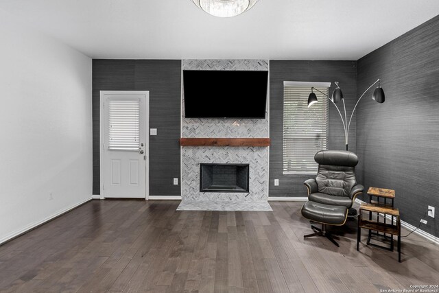 living room featuring dark wood-type flooring and a fireplace