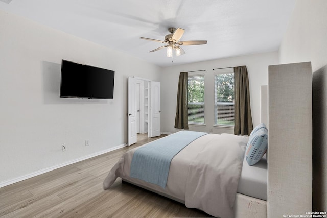 bedroom with ceiling fan and light wood-type flooring