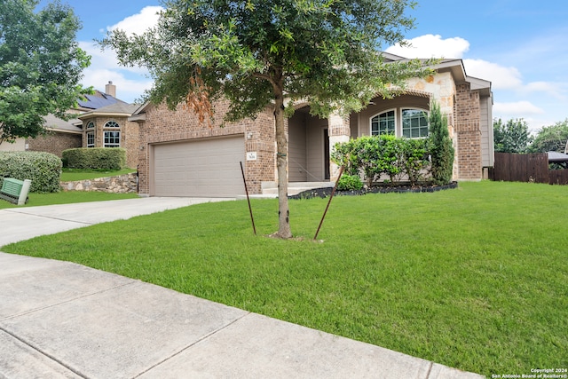 view of front of property with a garage and a front yard