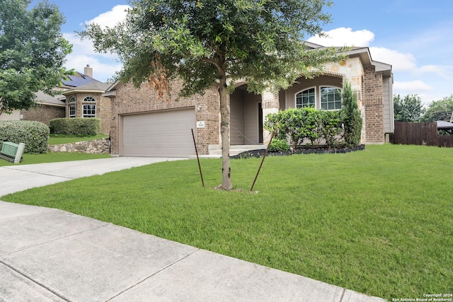 view of front facade with a front lawn and a garage