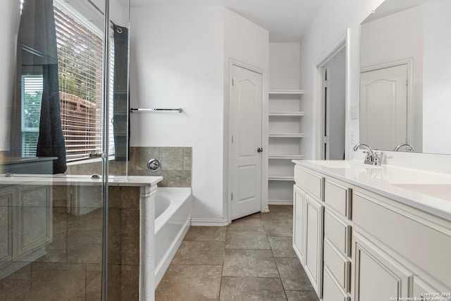 bathroom with tile flooring, separate shower and tub, and vanity