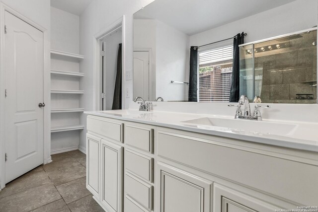 bathroom featuring tile floors and dual vanity