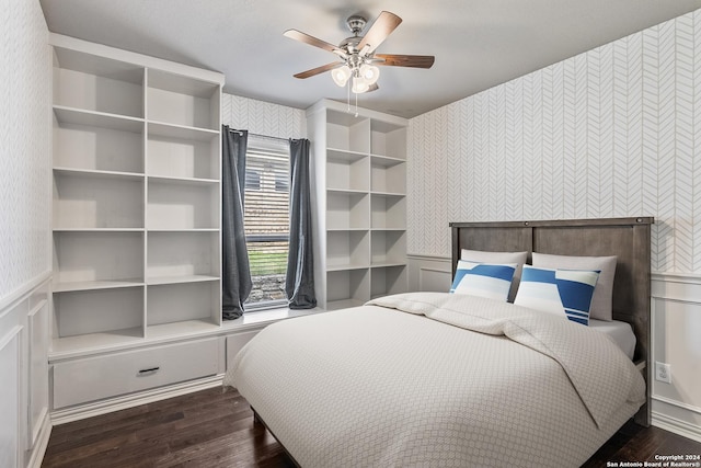 bedroom with dark hardwood / wood-style floors and ceiling fan