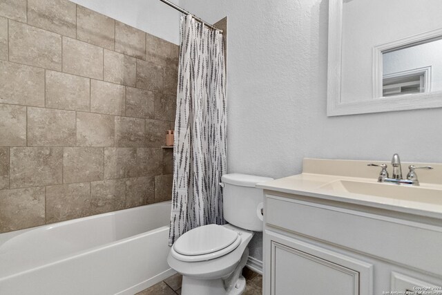 full bathroom with tile floors, shower / tub combo, vanity, and toilet