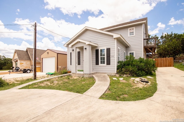 view of property featuring an outbuilding, a front yard, and a garage