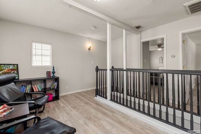 office with ceiling fan and light hardwood / wood-style flooring