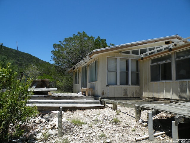 view of home's exterior featuring a wooden deck