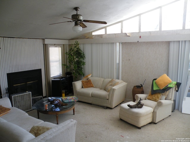 living room featuring ceiling fan, lofted ceiling, and carpet flooring