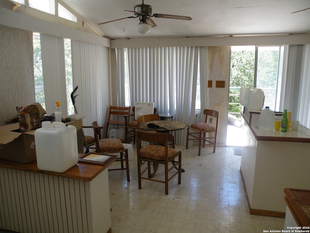 interior space with a wealth of natural light, ceiling fan, and vaulted ceiling