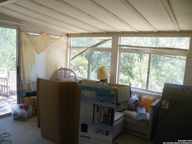 interior space featuring lofted ceiling and plenty of natural light