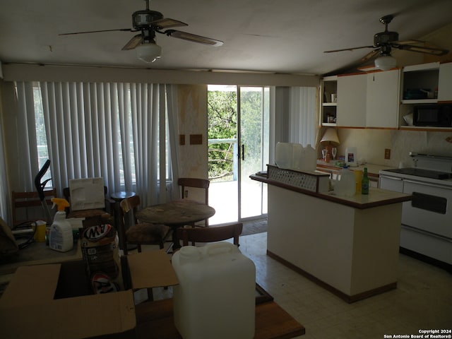 kitchen with white cabinetry, a kitchen island, white electric stove, and ceiling fan