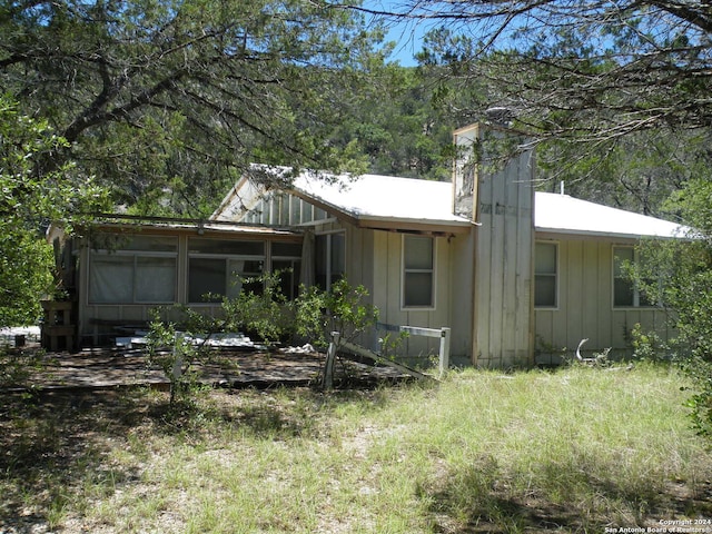 back of house featuring a sunroom