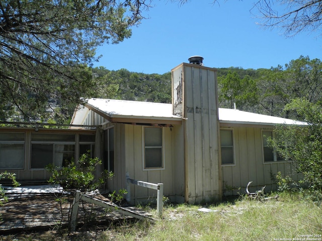 rear view of property featuring a sunroom