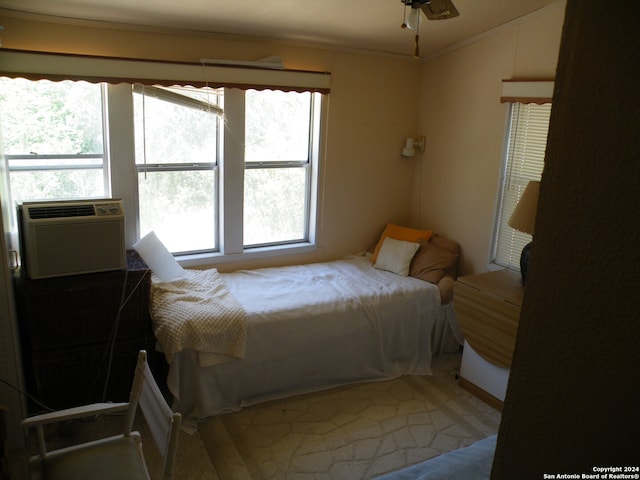 carpeted bedroom with ceiling fan, crown molding, and lofted ceiling