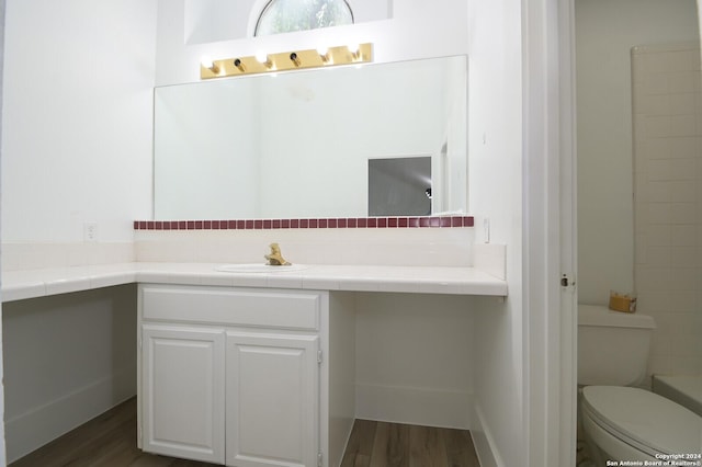 bathroom with hardwood / wood-style floors, vanity, and toilet