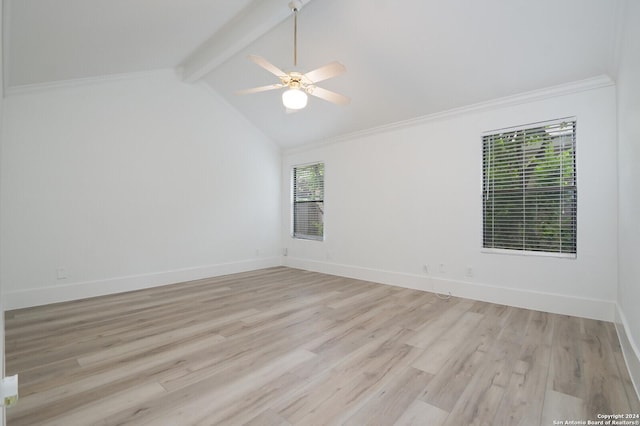 spare room with vaulted ceiling with beams, plenty of natural light, and light hardwood / wood-style flooring