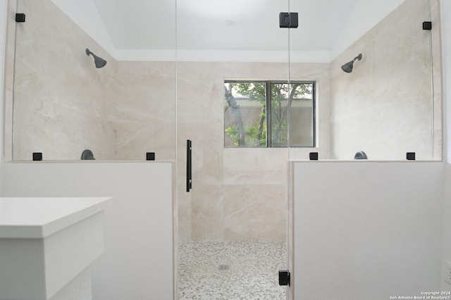 bathroom featuring an enclosed shower and lofted ceiling