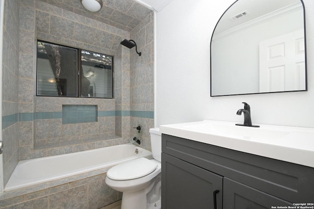 full bathroom with vanity, toilet, ornamental molding, and tiled shower / bath