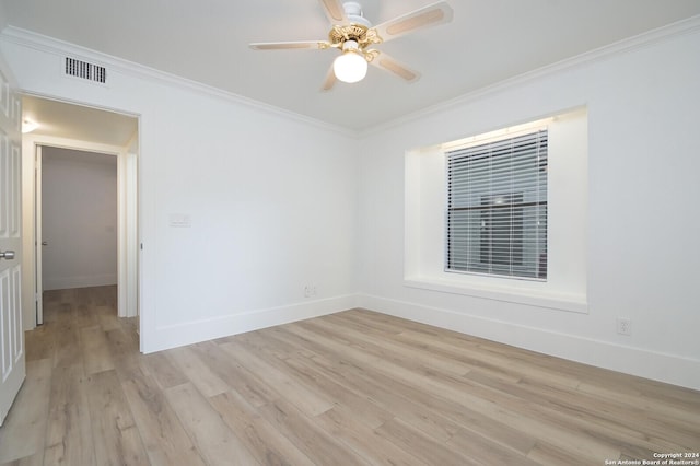 spare room with ceiling fan, light wood-type flooring, and ornamental molding