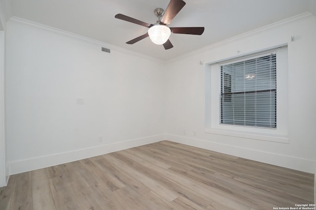 empty room featuring light wood-type flooring, ceiling fan, and crown molding