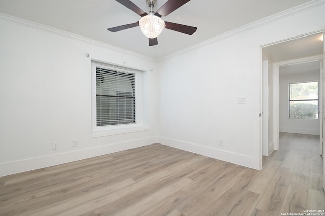 spare room with light wood-type flooring, ceiling fan, and crown molding