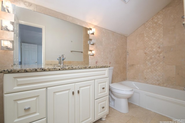 bathroom with vanity, tile patterned flooring, a washtub, toilet, and tile walls